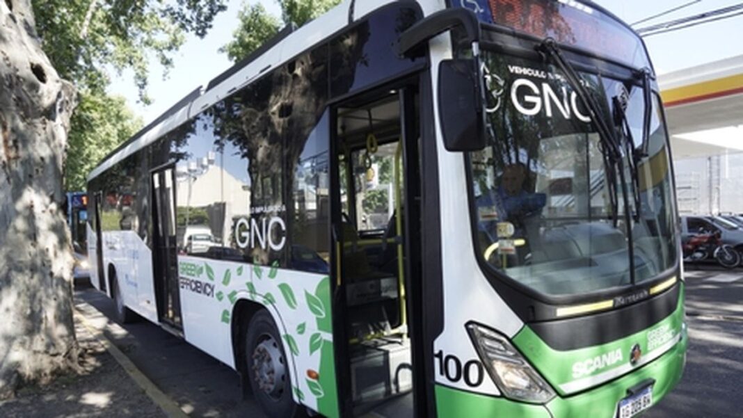 Colectivo urbano moderno con la leyenda 'GNC' estacionado en una calle de Rosario